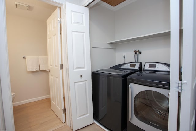 14 Hubbard Run Dr Unit 14, Glastonbury, CT 06033 - laundry room with washing machine and clothes dryer, light wood finished floors, baseboards, and crown molding