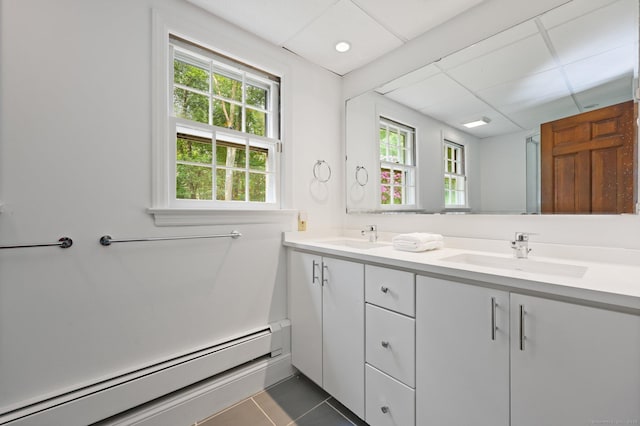 58 Lantern Ridge Rd, New Canaan, CT 06840 - full bath featuring a baseboard radiator, double vanity, healthy amount of natural light, and tile patterned flooring