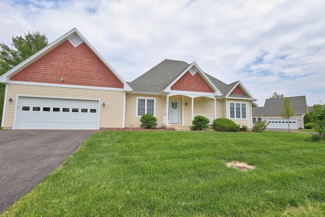 136 Thistle Pond Dr Unit 136, Bloomfield, CT 06002 - view of front of house featuring asphalt driveway, a front yard, an attached garage, and a shingled roof