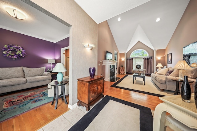 136 Thistle Pond Dr Unit 136, Bloomfield, CT 06002 - living area featuring a fireplace with flush hearth, baseboards, wood finished floors, and vaulted ceiling