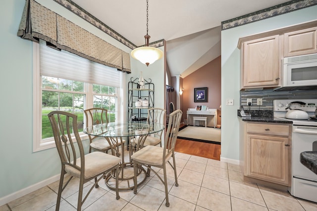 136 Thistle Pond Dr Unit 136, Bloomfield, CT 06002 - dining room with vaulted ceiling, baseboards, and light tile patterned floors