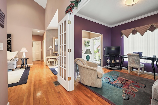 136 Thistle Pond Dr Unit 136, Bloomfield, CT 06002 - living room featuring wood finished floors, french doors, baseboards, and crown molding