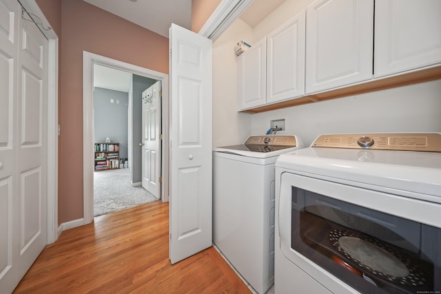 136 Thistle Pond Dr Unit 136, Bloomfield, CT 06002 - laundry room with cabinet space, separate washer and dryer, and light wood-style floors