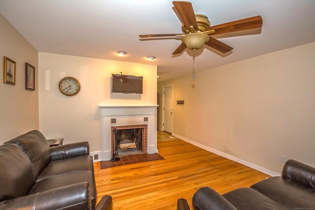 407 Monson Rd, Wilbraham, MA 01095 - living area with ceiling fan, a tiled fireplace, and wood finished floors