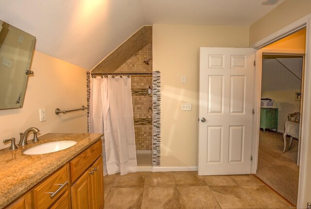 407 Monson Rd, Wilbraham, MA 01095 - bathroom featuring a tile shower, vanity, lofted ceiling, and tile patterned floors