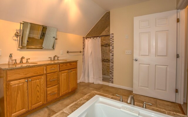 407 Monson Rd, Wilbraham, MA 01095 - full bath featuring tiled shower, double vanity, and lofted ceiling