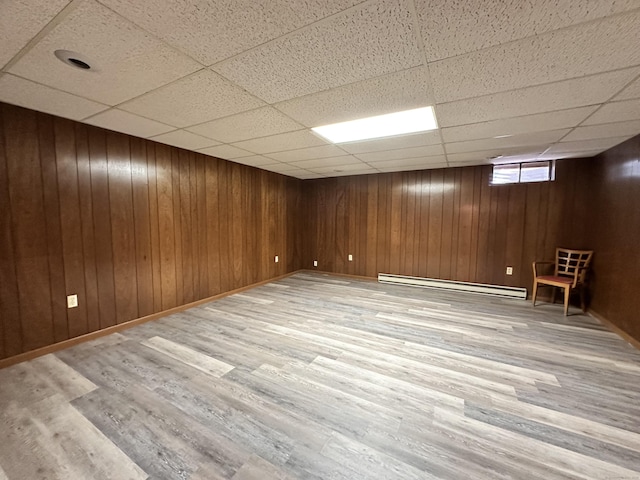 2 Briar Ct Unit 2, Cromwell, CT 06416 - basement with baseboard heating, wood finished floors, a drop ceiling, wooden walls, and baseboards