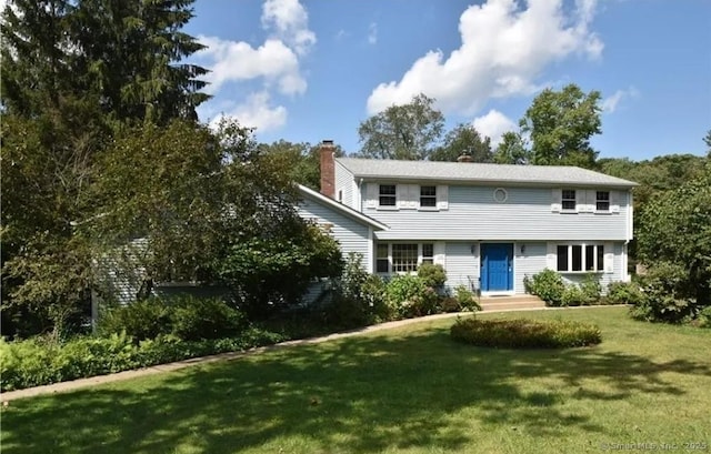 240 Mountain Spring Rd, Tolland, CT 06084 - colonial house with a front lawn and a chimney