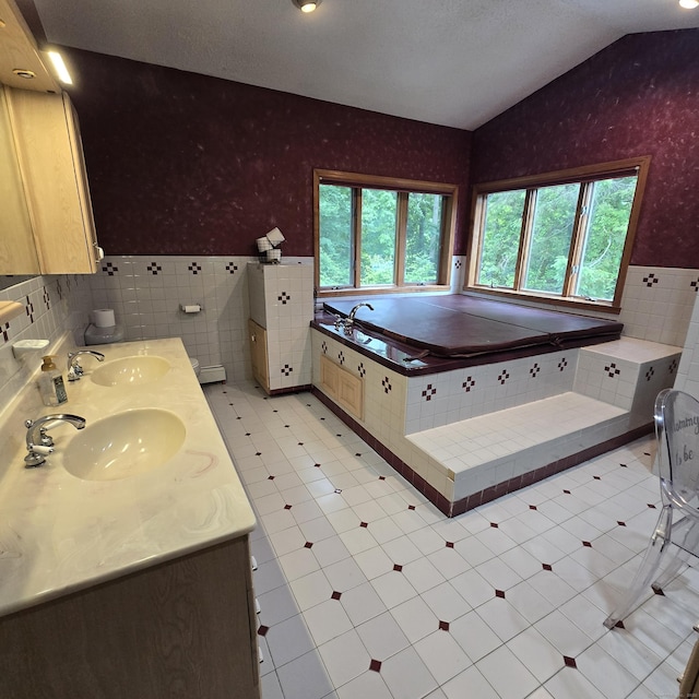 240 Mountain Spring Rd, Tolland, CT 06084 - bathroom featuring wallpapered walls, plenty of natural light, a wainscoted wall, tile walls, and a garden tub