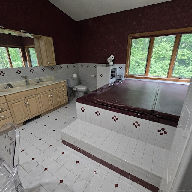 240 Mountain Spring Rd, Tolland, CT 06084 - bathroom with vanity, a bath, wainscoting, wallpapered walls, and tile walls