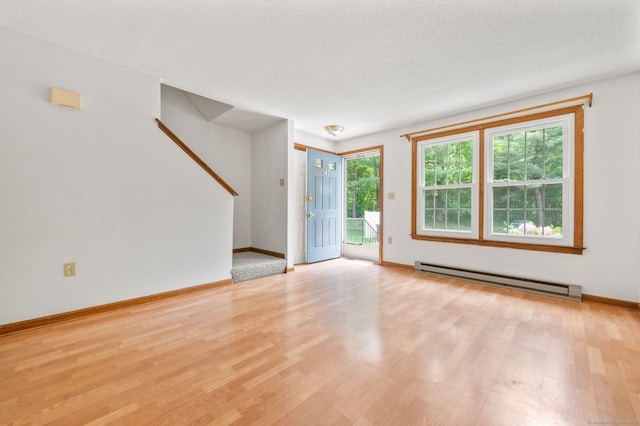 147 Julia Ter Unit 147, Middletown, CT 06457 - empty room with a baseboard heating unit, stairway, wood finished floors, and baseboards