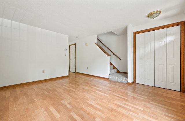 147 Julia Ter Unit 147, Middletown, CT 06457 - unfurnished living room featuring light wood-type flooring, stairs, and baseboards