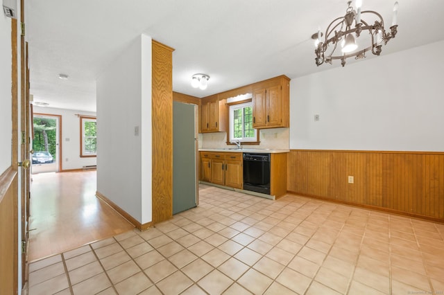 147 Julia Ter Unit 147, Middletown, CT 06457 - kitchen with black dishwasher, freestanding refrigerator, a chandelier, light countertops, and a wainscoted wall