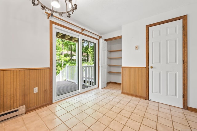 147 Julia Ter Unit 147, Middletown, CT 06457 - empty room with baseboard heating, wainscoting, wood walls, a chandelier, and light tile patterned flooring
