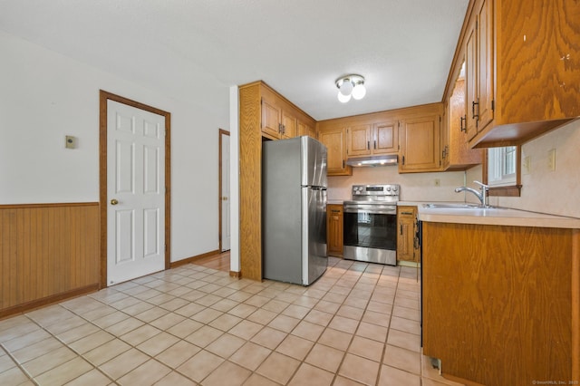 147 Julia Ter Unit 147, Middletown, CT 06457 - kitchen with stainless steel appliances, under cabinet range hood, a sink, light countertops, and brown cabinets