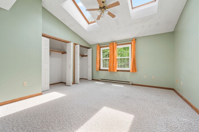 147 Julia Ter Unit 147, Middletown, CT 06457 - unfurnished bedroom featuring a skylight, baseboard heating, multiple closets, lofted ceiling, and carpet flooring