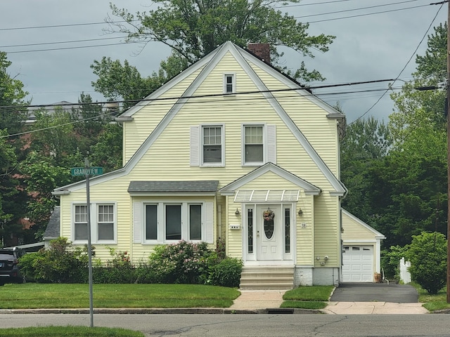 38 Grandview Ave, Hamden, CT 06514 - colonial inspired home featuring a chimney, a garage, a front yard, and asphalt driveway