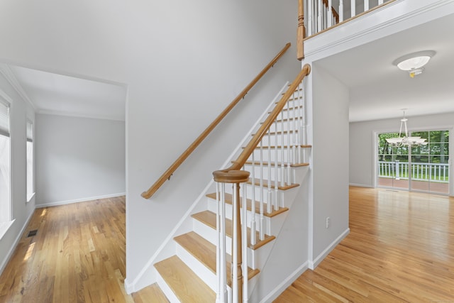 8 Stone Gate Dr, Newtown, CT 06482 - stairway with a chandelier, wood finished floors, and ornamental molding