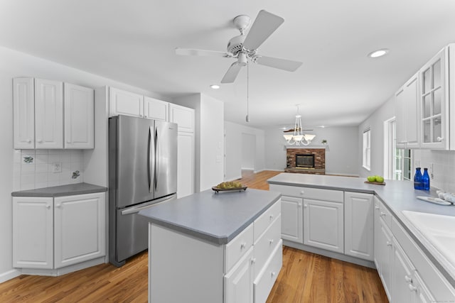 8 Stone Gate Dr, Newtown, CT 06482 - kitchen featuring freestanding refrigerator, recessed lighting, light wood-style floors, decorative backsplash, and white cabinets