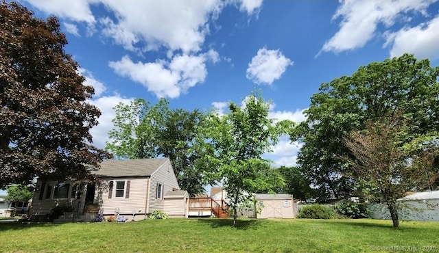 12 Hart Pl, Plainville, CT 06062 - view of grassy yard featuring a storage shed and a wooden deck