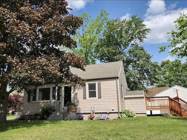 12 Hart Pl, Plainville, CT 06062 - obstructed view of property featuring a front lawn, a deck, and roof with shingles