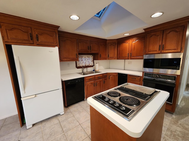 12 Hart Pl, Plainville, CT 06062 - kitchen with black appliances, a skylight, light countertops, light tile patterned floors, and recessed lighting