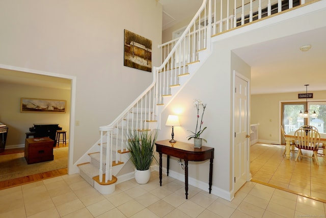 108 Northwood Dr, Easton, CT 06612 - staircase with tile patterned floors, a towering ceiling, and baseboards
