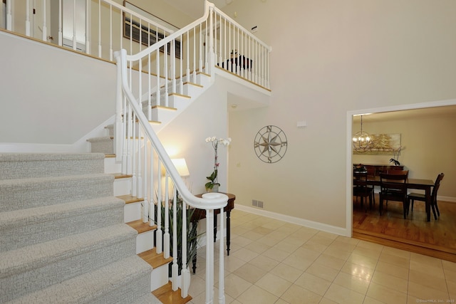 108 Northwood Dr, Easton, CT 06612 - stairway with baseboards, a high ceiling, tile patterned floors, and a chandelier