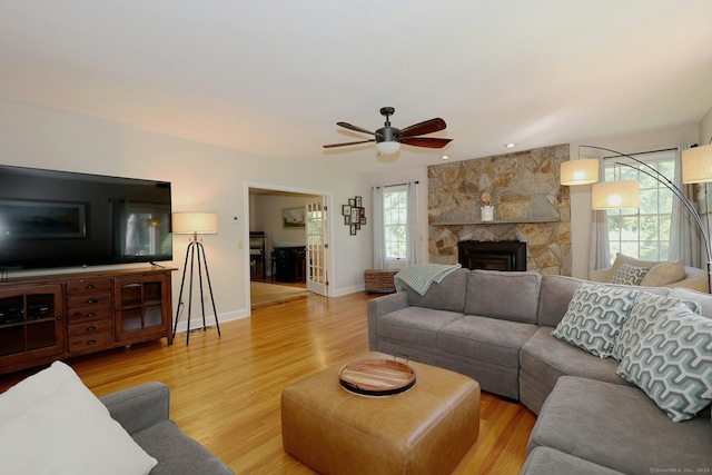 108 Northwood Dr, Easton, CT 06612 - living room featuring a ceiling fan, light wood-type flooring, baseboards, and a stone fireplace