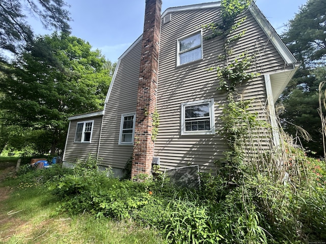 53 Falls Bashan Rd, East Haddam, CT 06469 - view of property exterior with a chimney