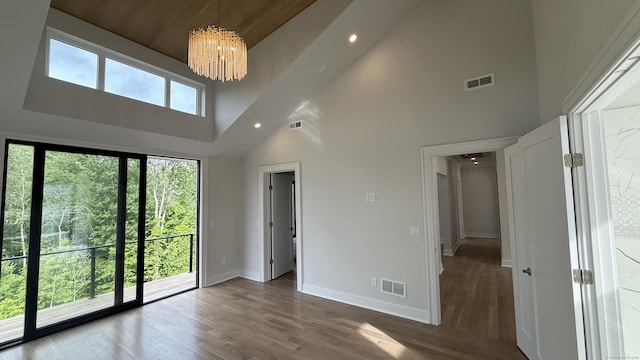 20 N Lake Shore Dr, Brookfield, CT 06804 - spare room with baseboards, a chandelier, a towering ceiling, recessed lighting, and wood finished floors