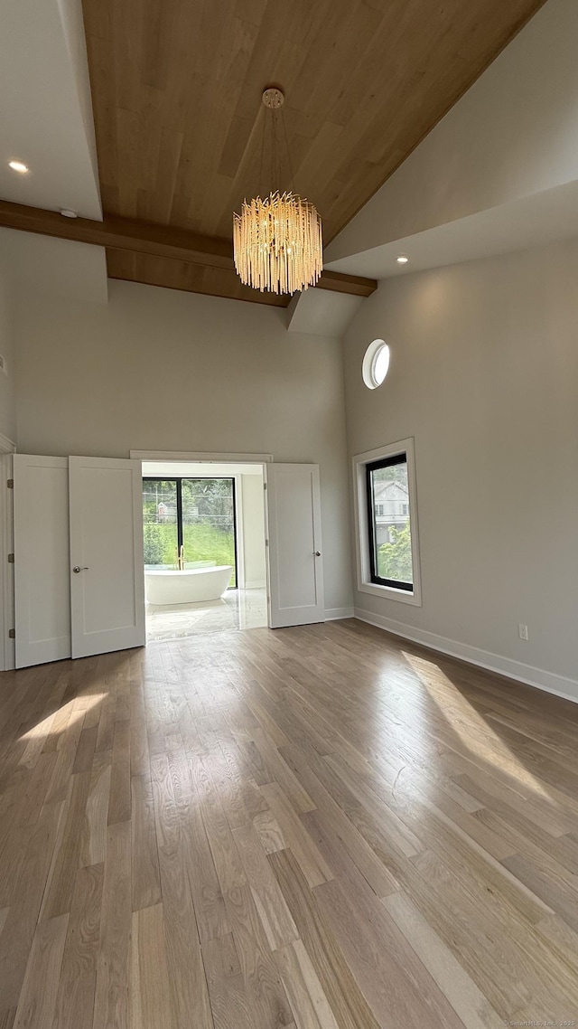 20 N Lake Shore Dr, Brookfield, CT 06804 - unfurnished living room featuring high vaulted ceiling, a chandelier, wood finished floors, wooden ceiling, and baseboards