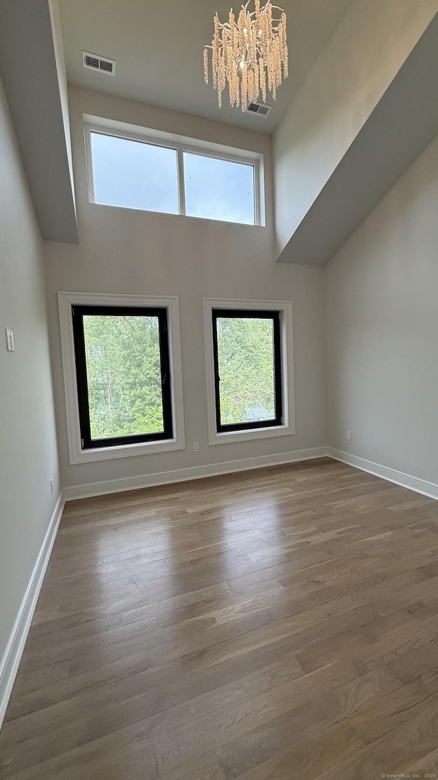 20 N Lake Shore Dr, Brookfield, CT 06804 - empty room with a chandelier, a high ceiling, wood finished floors, and baseboards