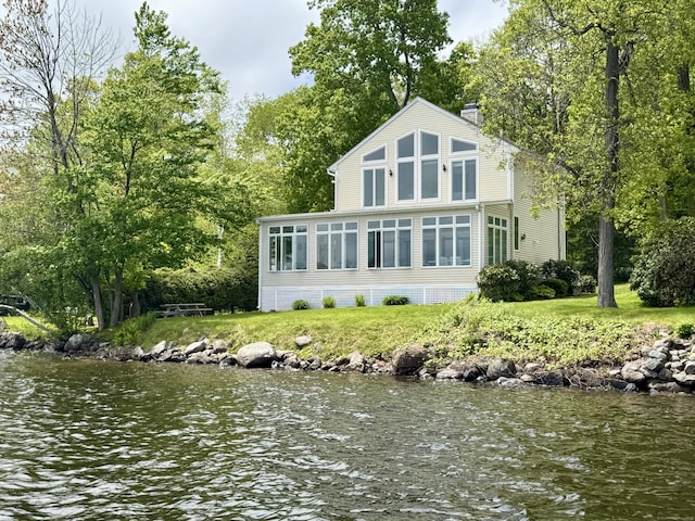300 Bantam Lake Rd Unit 10, Morris, CT 06763 - rear view of house featuring a chimney, a sunroom, and a water view