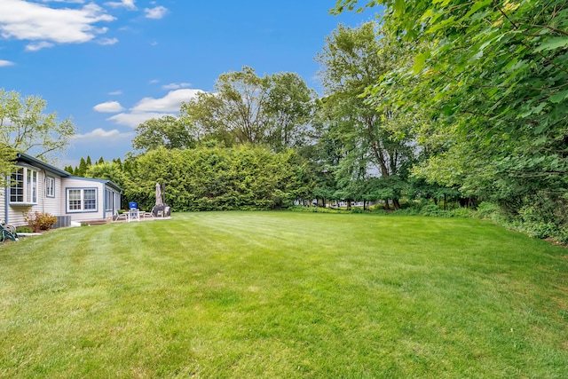 131 Ridgeview Ave, Trumbull, CT 06611 - view of grassy yard with central AC and view of scattered trees