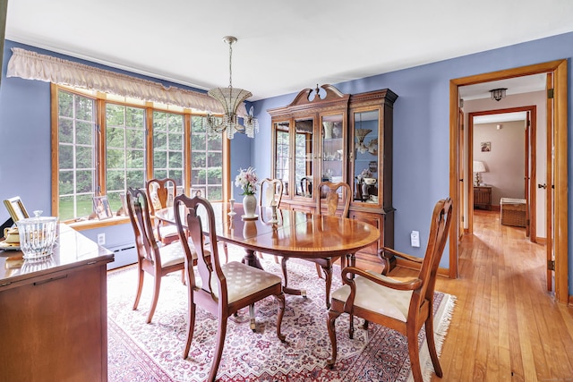 131 Ridgeview Ave, Trumbull, CT 06611 - dining room with a chandelier, light wood-type flooring, and baseboards