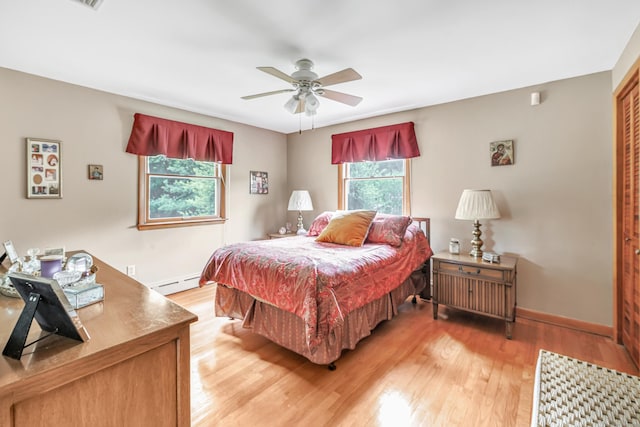 131 Ridgeview Ave, Trumbull, CT 06611 - bedroom with a baseboard radiator, multiple windows, and light wood-style flooring