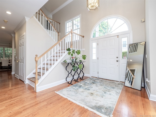 10 Wilton Hls Unit 10, Wilton, CT 06897 - entrance foyer featuring stairway, wood finished floors, crown molding, a high ceiling, and baseboards