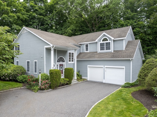 10 Wilton Hls Unit 10, Wilton, CT 06897 - view of front facade featuring roof with shingles, driveway, and view of scattered trees