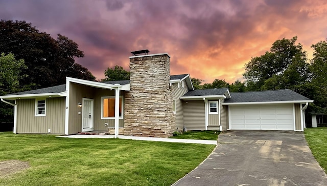 9 Grieb Rd, Wallingford, CT 06492 - mid-century home featuring a garage, a chimney, a front lawn, and driveway