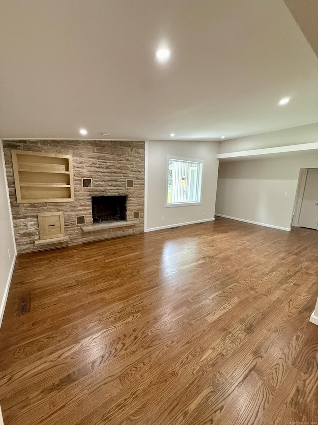 9 Grieb Rd, Wallingford, CT 06492 - unfurnished living room featuring wood finished floors, baseboards, recessed lighting, a fireplace, and built in shelves