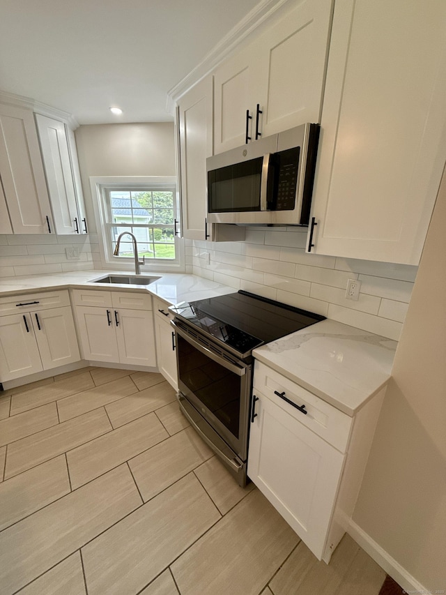 9 Grieb Rd, Wallingford, CT 06492 - kitchen featuring stainless steel appliances, a sink, tasteful backsplash, white cabinetry, and recessed lighting
