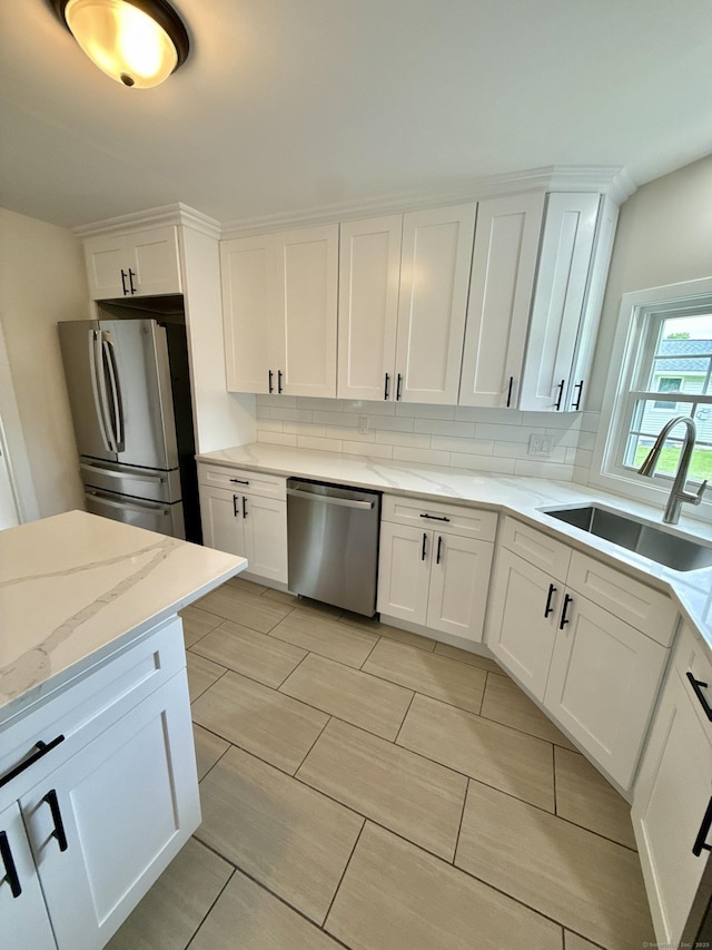 9 Grieb Rd, Wallingford, CT 06492 - kitchen with appliances with stainless steel finishes, a sink, backsplash, and white cabinets