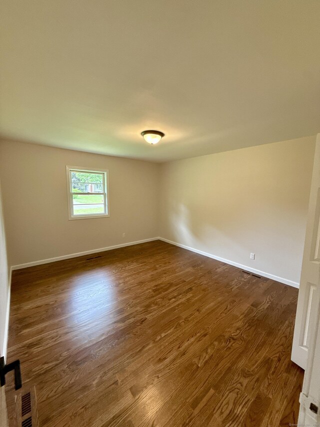 9 Grieb Rd, Wallingford, CT 06492 - empty room with dark wood finished floors and baseboards