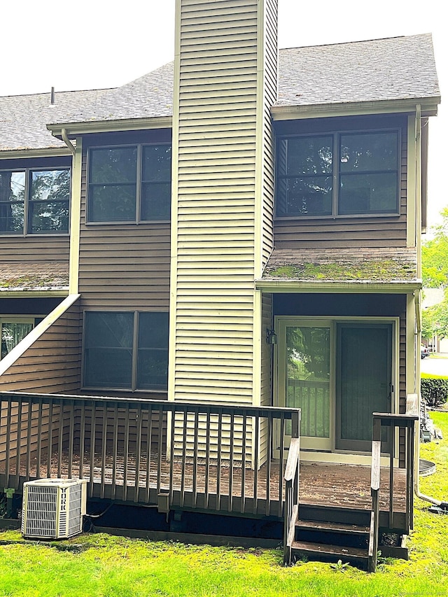 366 Ash St # 31, Windham, CT 06226 - back of house featuring central AC unit, a chimney, and a shingled roof