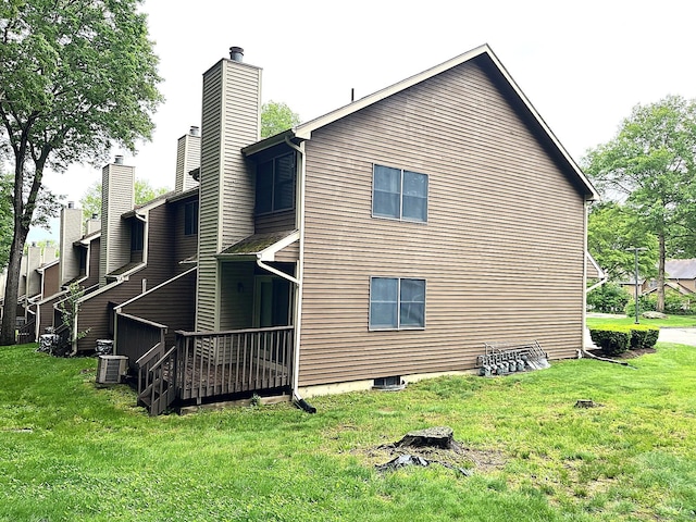 366 Ash St # 31, Windham, CT 06226 - view of property exterior with a chimney, a lawn, and central AC unit
