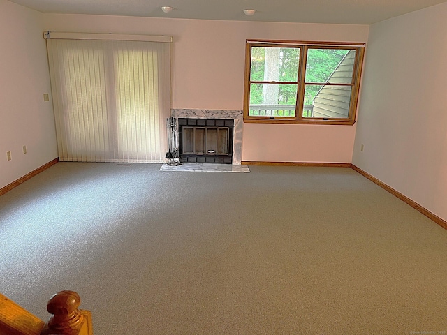 366 Ash St # 31, Windham, CT 06226 - unfurnished living room with a high end fireplace, baseboards, and carpet flooring