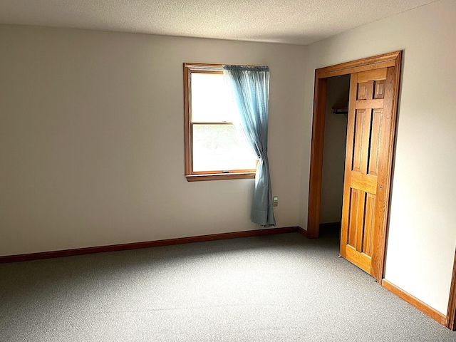 366 Ash St # 31, Windham, CT 06226 - unfurnished bedroom featuring carpet flooring, baseboards, and a textured ceiling