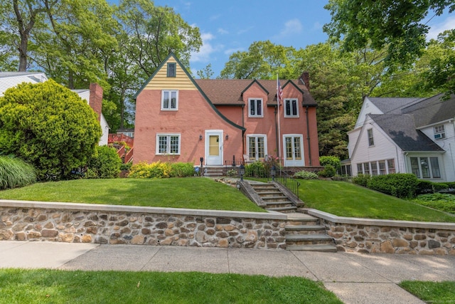 73 Hemlock Rd, New Haven, CT 06515 - tudor house featuring a front yard, a chimney, and stucco siding