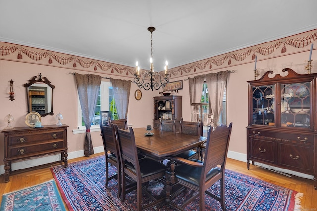 73 Hemlock Rd, New Haven, CT 06515 - dining space featuring a chandelier, plenty of natural light, ornamental molding, and light wood-style flooring